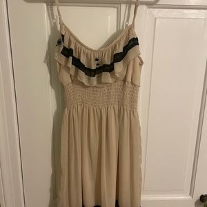 Cream flowy dress with black detail.